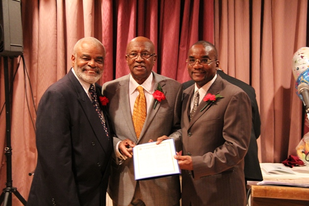 In this In 2012 picture, Matthew Okebiyi receives a “U.S. Congressional Record of Honor” award presented to him by Walter Campbell (L) and the Honorable Congressman Edolphus “Ed” Towns (C) for his outstanding service to the community.